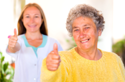 Elder and nurse showing thumbs up