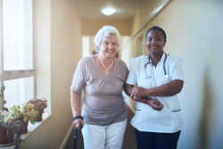 Elder and nurse walking together